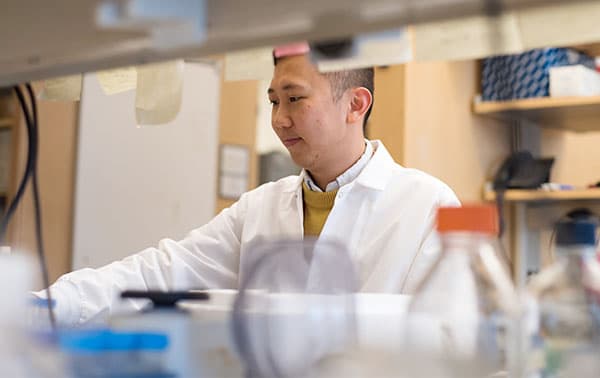 Trainee sitting at a lab bench.
