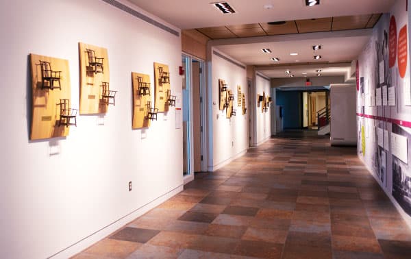 Two people walk along the Milwaukee lakefront passing the beautiful Milwaukee Art Museum.