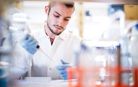 Lab technician loading a sample.