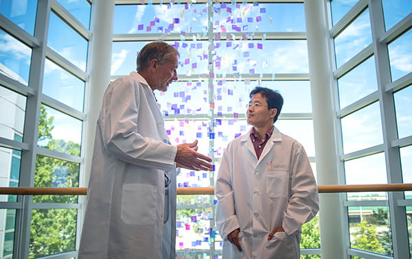 Hartmut Weiler, PhD and Jieqing Zhu, PhD discussing in the VBRI atrium.
