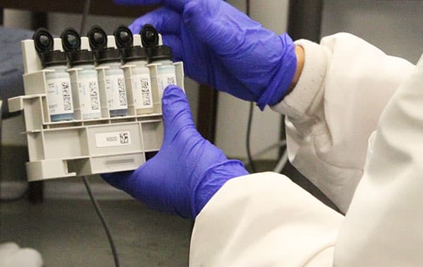 Technician testing blood samples.