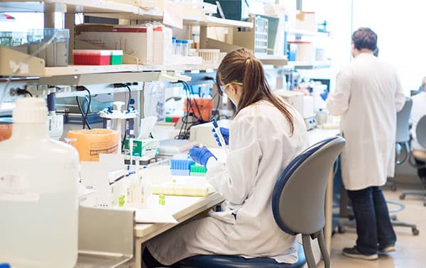 Lab technician conducting tests on samples.