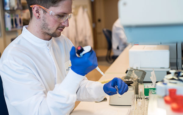 Technician testing sample.