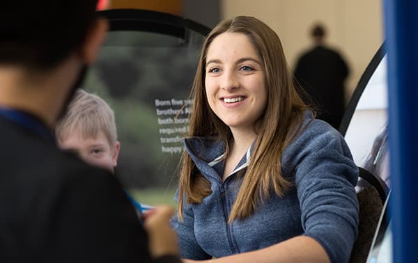 Emily, smiling during her pre-appointment screening.
