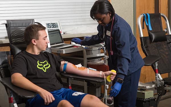 Gavin, giving blood at a mobile blood drive