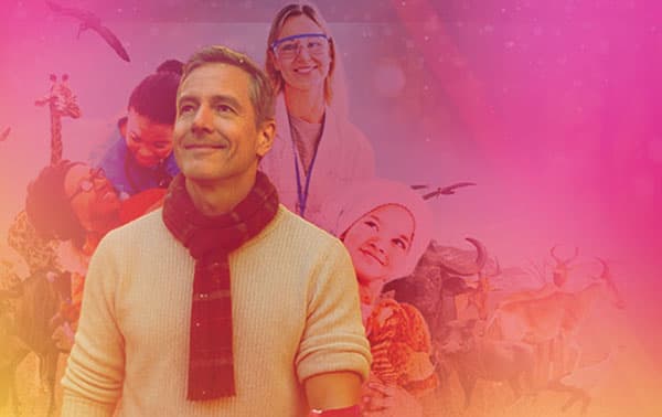 People smiling with animals in the background.