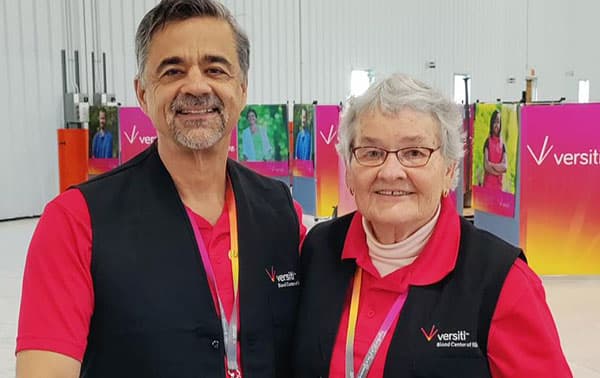 Smiling volunteers at a blood drive.