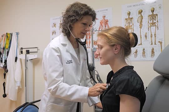 Dr. Lisa Baumann Kreuziger working with a patient.