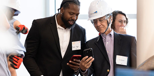 Two attendees at the Versiti Blood Research Institute Expansion Topping-Off Milestone Event