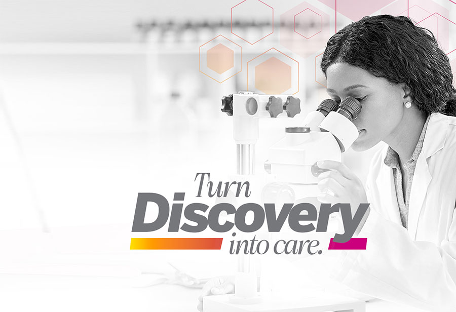 Scientist looking into microscope