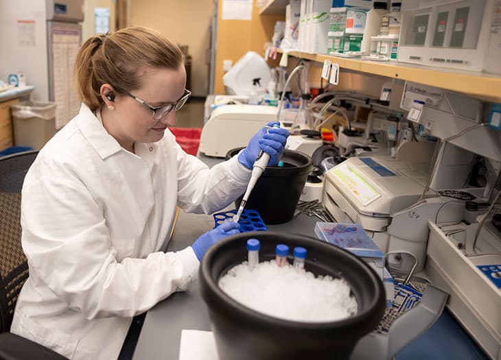 A researcher pipetting some blood samples.
