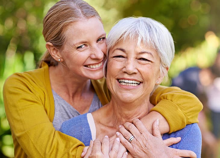 Smiling daughter and mother.