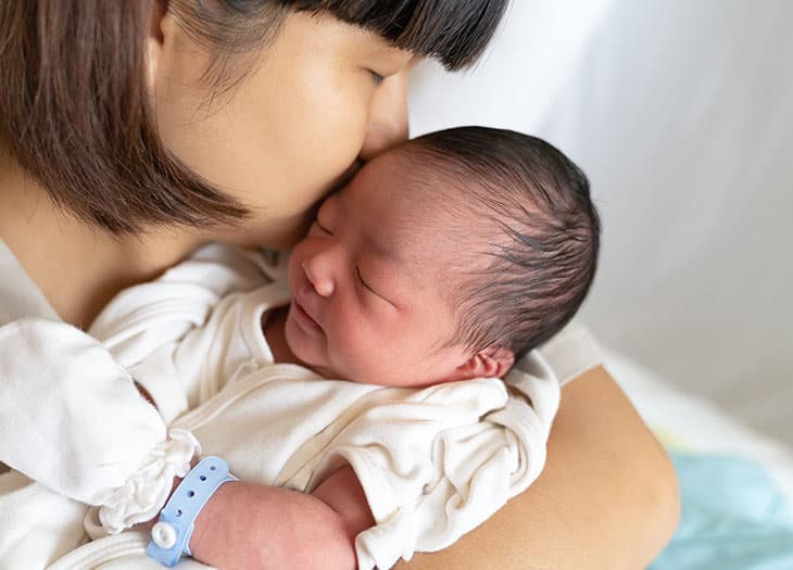 Mother lovingly holding baby