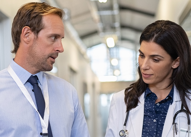 A doctor and a consultant having a conversation.