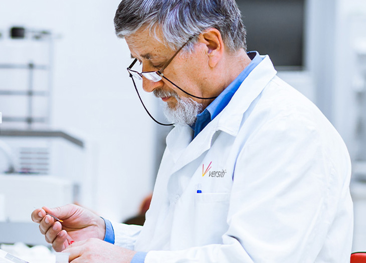 Researcher jotting something down in a book.